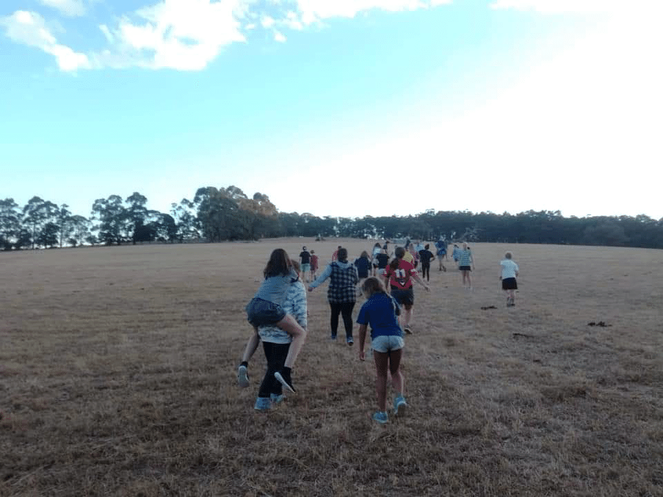 Mill Valley Ranch young people crossing a field